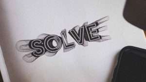 The word, “Solve,” is printed in a unique design on a white piece of paper.