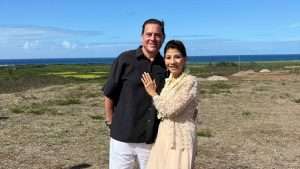 Howie & Theresa Danizk™ stand on the ocean coastline.